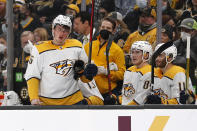 Nashville Predators' Philip Tomasino gets to the bench bloodied after taking a hit during the first period of an NHL hockey game against the Boston Bruins Saturday, Jan. 15, 2022, in Boston. (AP Photo/Winslow Townson)