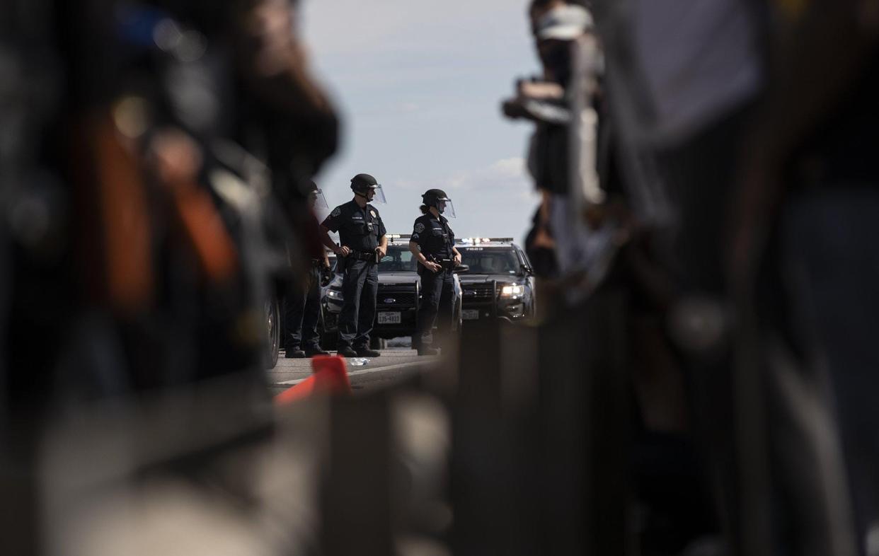 Austin police officers take back southbound Interstate 35 after demonstrators protesting the police killings of George Floyd and Michael Ramos blocked the freeway on May 30, 2020. Injuries suffered during the May 2020 protests led to charges against several officers, but 17 of those 21 cases have been dropped.