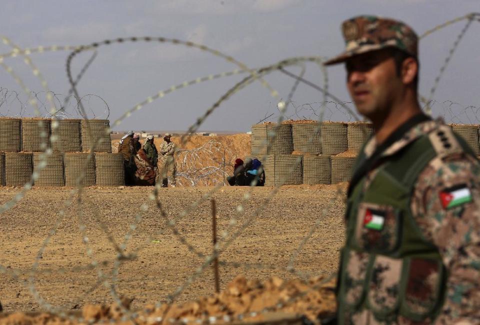 In this picture taken Tuesday, Feb. 14, 2017, a Jordanian soldier stands at the north eastern border with Syria, close to the informal Rukban camp. The commander of Jordan's border guards says Islamic State extremists are expanding their influence in the sprawling border camp for tens of thousands of displaced Syrians, posing a growing threat to the U.S.-allied kingdom. (AP Photo/ Raad Adayleh)