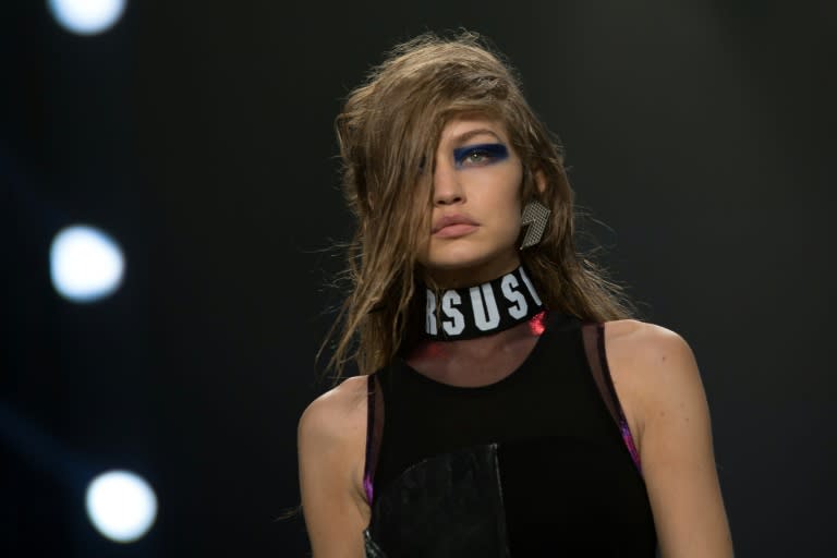 US model Gigi Hadid presents a creation by Versus (Versace) during a catwalk show at London Fashion Week