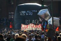 <p>Protesters hold placards as they wait for the demonstration during the G-20 summit in Hamburg, Germany, July 6, 2017. (Photo: Kai Pfaffenbach/Reuters) </p>