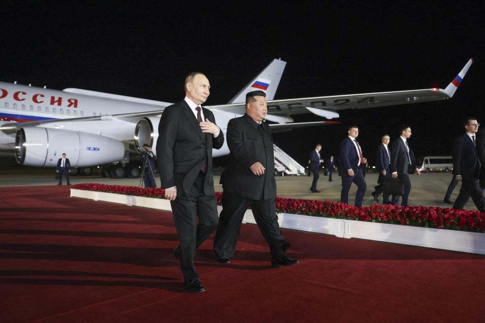 Russian President Vladimir Putin, right, and North Korea's leader Kim Jong Un walk at the Pyongyang Sunan International Airport outside Pyongyang, North Korea, on Tuesday, June 18, 2024. (Gavriil Grigorov, Sputnik, Kremlin Pool Photo via AP)