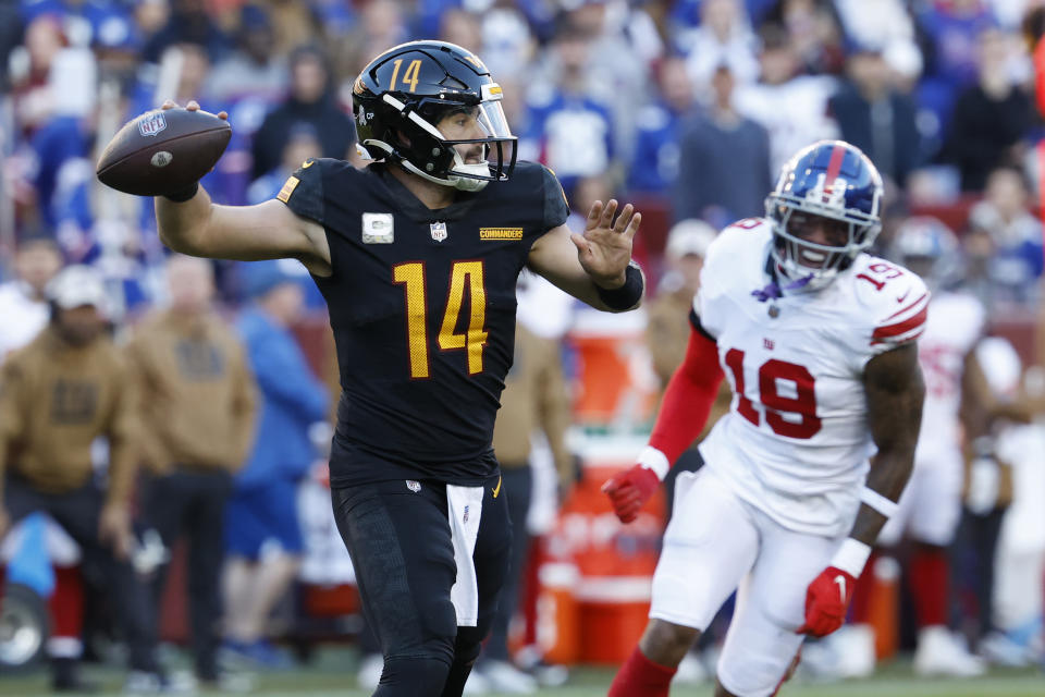 Washington Commanders quarterback Sam Howell (14) passes the ball as New York Giants wide receiver <a class="link " href="https://sports.yahoo.com/nfl/players/32877" data-i13n="sec:content-canvas;subsec:anchor_text;elm:context_link" data-ylk="slk:Isaiah Hodgins;sec:content-canvas;subsec:anchor_text;elm:context_link;itc:0">Isaiah Hodgins</a> (18). Mandatory Credit: Geoff Burke-USA TODAY Sports