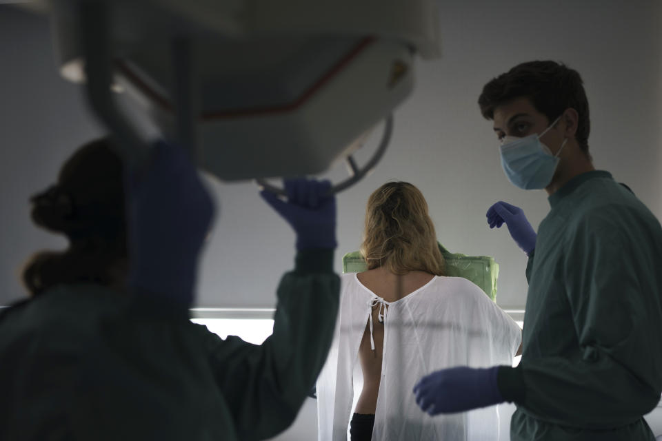 Health workers prepare to perform an x-ray on a COVID-19 patient in the Hospital del Mar in Barcelona, Spain, Friday, July 9, 2021. (AP Photo/Felipe Dana)
