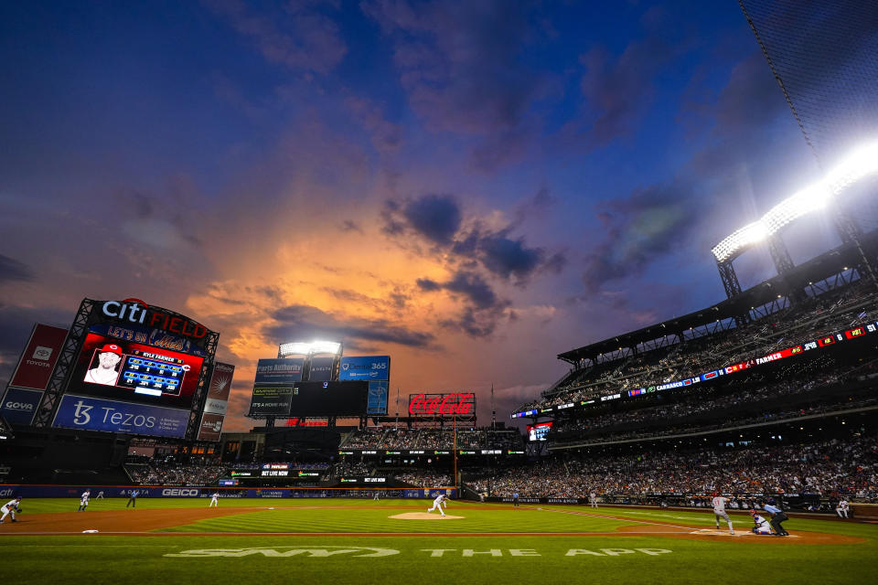 New York Mets' Carlos Carrasco pitches to Cincinnati Reds' Kyle Farmer during the first inning of a baseball game Tuesday, Aug. 9, 2022, in New York. (AP Photo/Frank Franklin II)