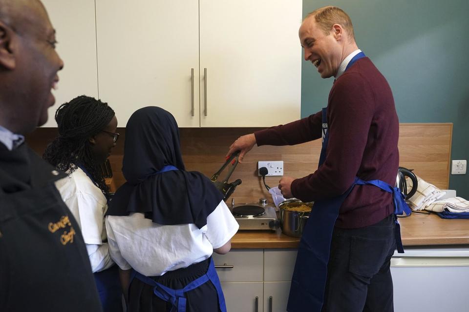 The Prince of Wales takes part in a cookery class during his visit to Together as One (until recently known as Aik Saath) in Slough