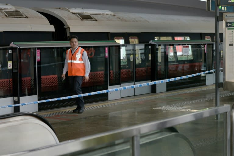 A SMRT staffer walks past one of the two trains that collided at a train station in Singapore on November 15, 2017