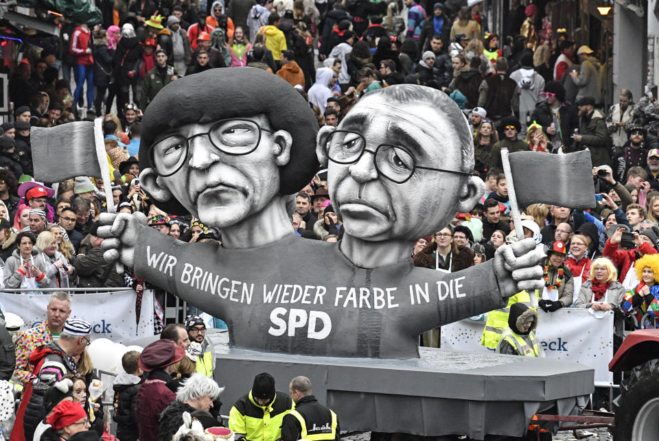 A carnival float depicts grey Social Democratc Party, SPD, leaders Saskia Esken and Norbert Walter-Borjans during the traditional carnival parade in Duesseldorf, Germany, on Monday, Feb. 24, 2020. The foolish street spectacles in the carnival centers of Duesseldorf, Mainz and Cologne, watched by hundreds of thousands of people, are the highlights in Germany's carnival season on Rosemonday. (AP Photo/Martin Meissner)