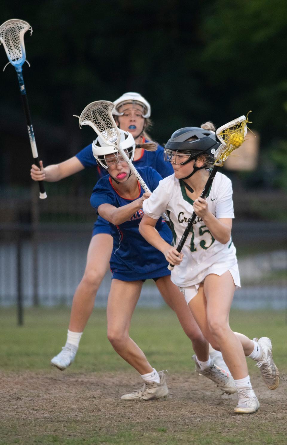 Catholic's Ella Adams (No. 15)) looks for a shot on goal as Bolles defenders try to break up the play during Friday's District 1-A girls' lacrosse semi-finals match. 