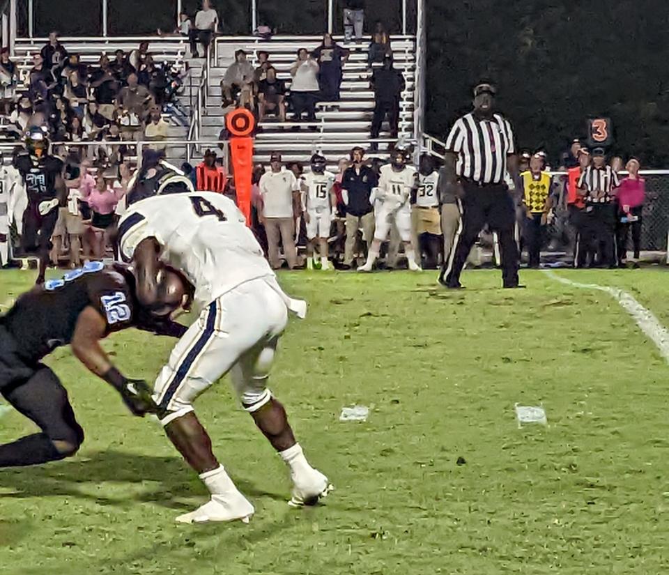 University Christian running back Orel Gray (4) attempts to break a tackle by Trinity Christian defensive back Elijah Crocker (12) during a high school football game on October 14, 2022. [Clayton Freeman/Florida Times-Union]