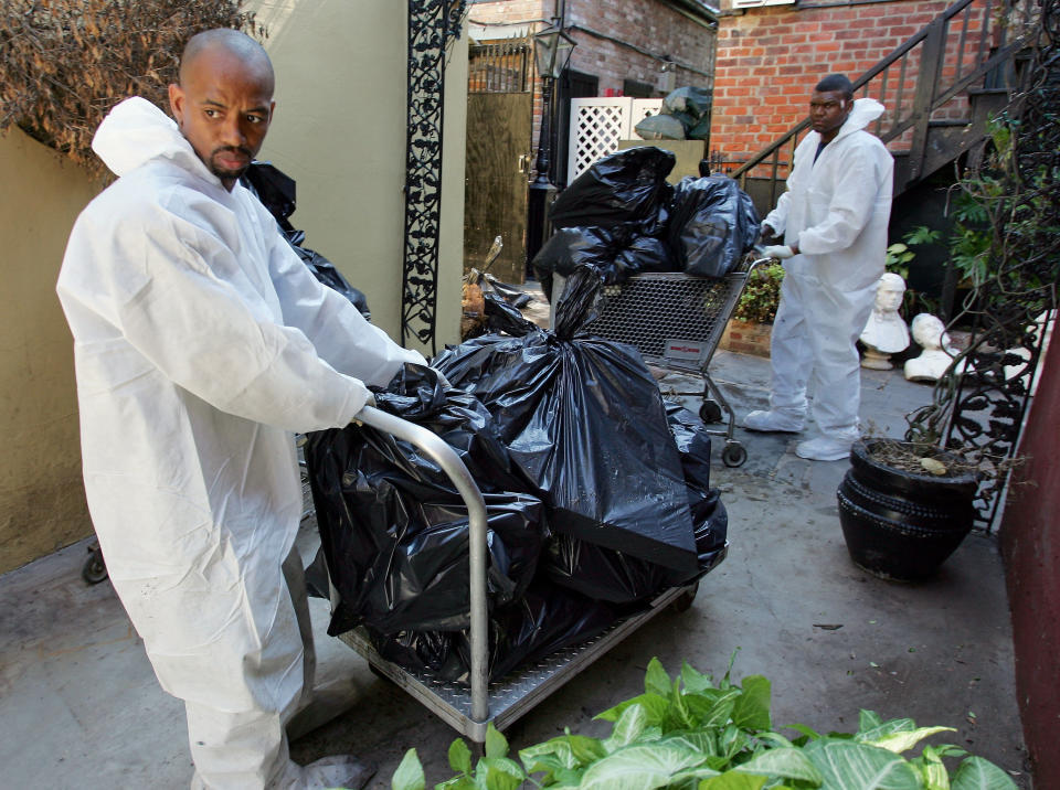 Following Katrina, Cedric Harrell (left) and Tom Miller remove spoiled food from the freezer at Court of Two Sisters restaurant in the French Quarter of New Orleans. (Photo: Ethan Miller/Getty Images)