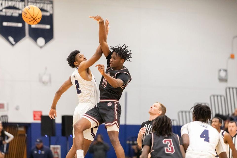 Dwyer's Amari Nealy (2) oges up against Lake Worth's Hedrens Barthelus (11) during a game on Jan. 30, 2024.