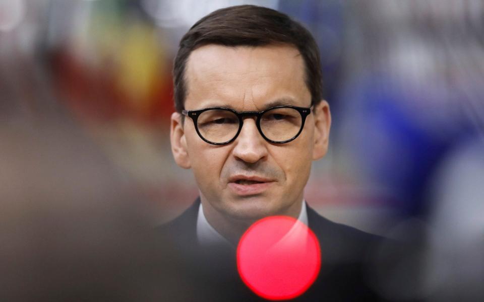 Prime Minister Mateusz Morawiecki speaks with the media as he arrives for an EU summit in Brussels in May. - EPA