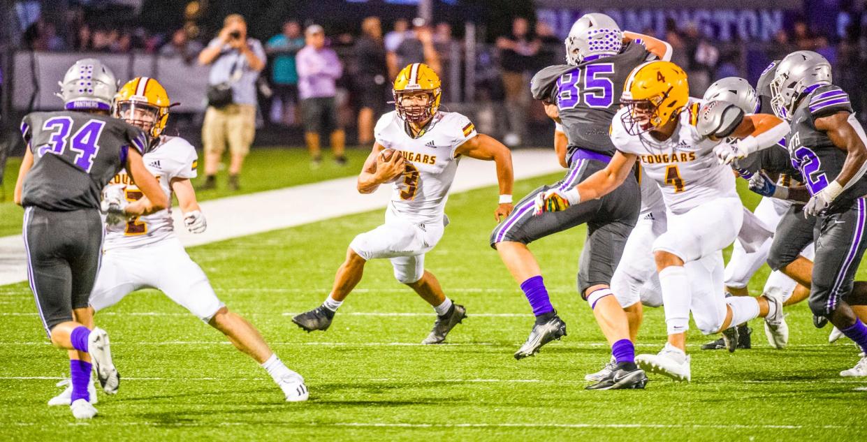 Bloomington North quarterback Reece Lozano (3) runs against Bloomington South in their September meeting. Lozano, North tight end Aidan Steinfeldt (4) and South linebacker Tysen Smith (85) were all named all-state.