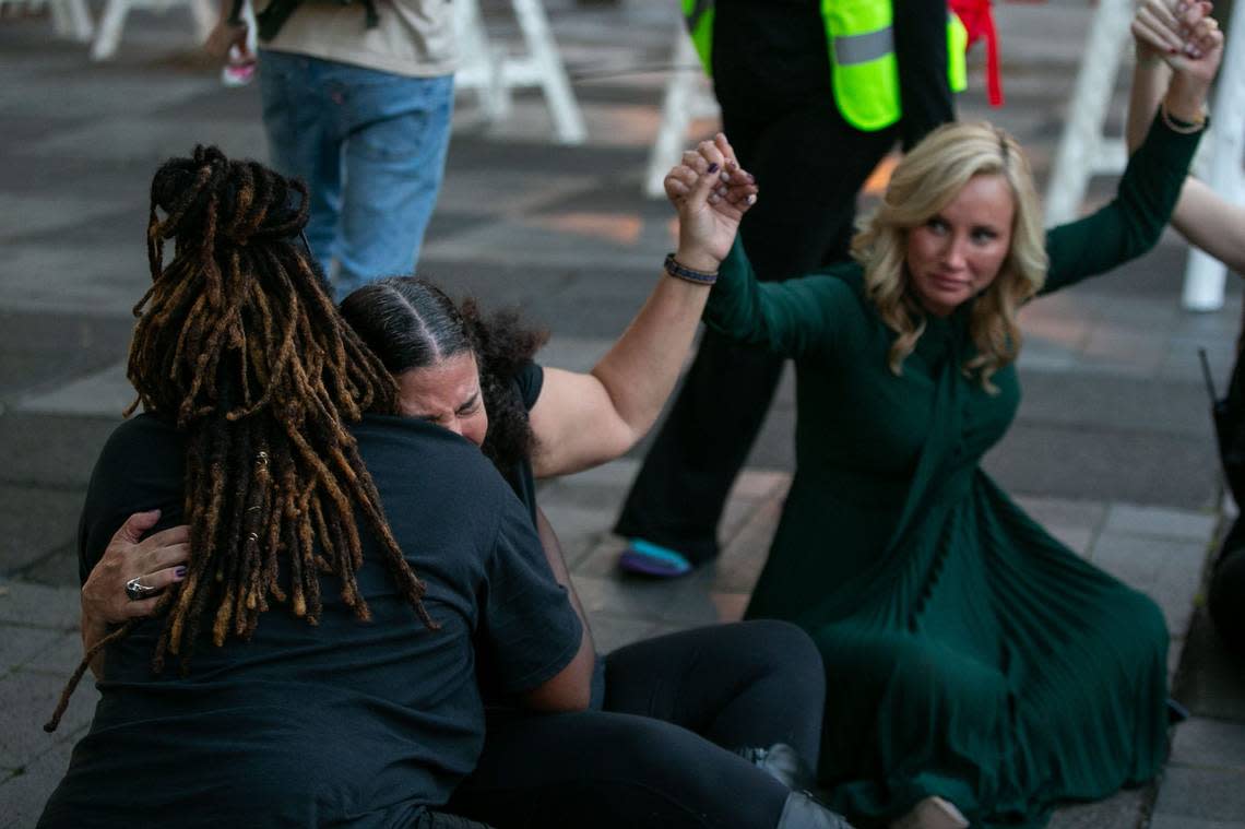 Sen. Lauren Book holds hands with roughly a dozen activists while protesting SB 300, which would place a ban on abortions after six weeks in Florida, while singing “Lean on Me,” Monday, April 3, 2023. The bill was passed by the Senate earlier in the day.