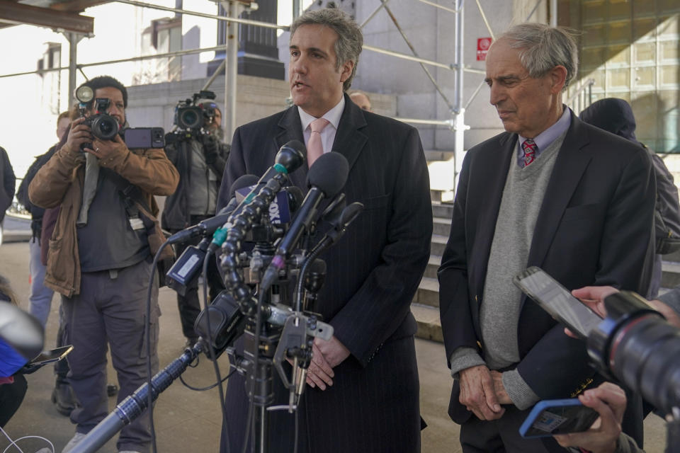 FILE - Donald Trump's former lawyer and fixer Michael Cohen, center, is joined by his attorney Lanny Davis as he speaks to reporters after a second day of testimony before a grand jury investigating hush money payments he arranged and made on the former president's behalf, March 15, 2023, in New York. (AP Photo/Mary Altaffer, File)