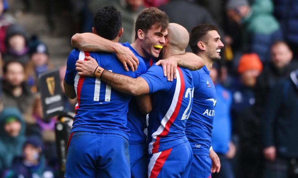 Damian Penaud is congratulated by his teammates after scoring France’s sixth try.