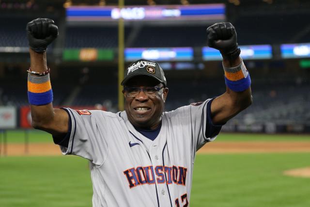 Dusty Baker celebrates the Astros' ALCS victory on the field at Yankee Stadium.