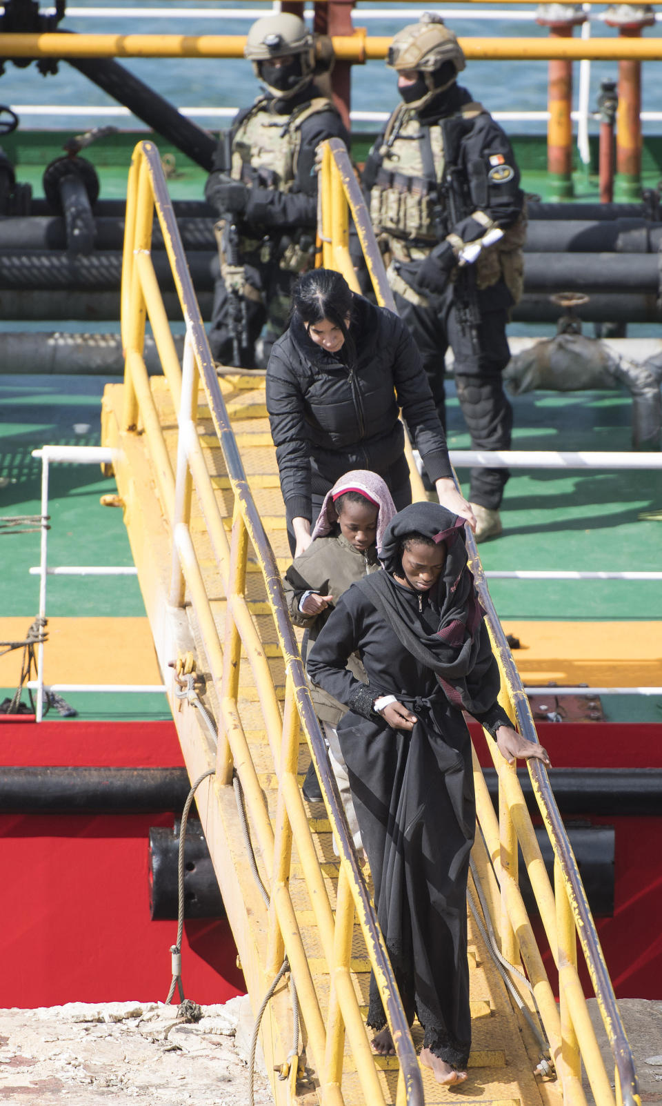 Armed forces stand onboard the Turkish oil tanker El Hiblu 1, which was hijacked by migrants, as migrants start to disembark in Valletta, Malta, Thursday March 28, 2019. A Maltese special operations team on Thursday boarded a tanker that had been hijacked by migrants rescued at sea, and returned control to the captain, before escorting it to a Maltese port. (AP Photo/Rene' Rossignaud)