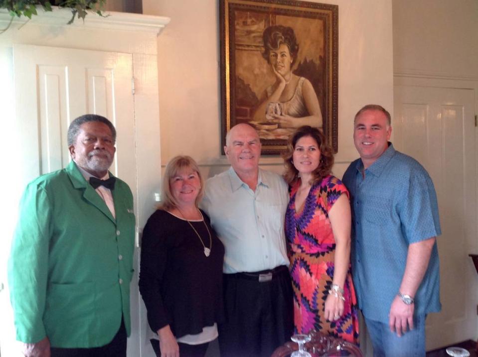 MARY PEREZ/SUN HERALD Carrying on the traditions of Mary Mahoney, who is pictured behind them at Mary Mahoney’s restaurant in Biloxi, are, from left, Marshall Johnson, who has worked at the restaurant for 44 years, and family members Eileen Mahoney Ezell, Bobby Mahoney Jr., Andrea Cvitanovich Osman and Tony Cvitanovich. The restaurant opened 50 years ago on May 7, 1964.