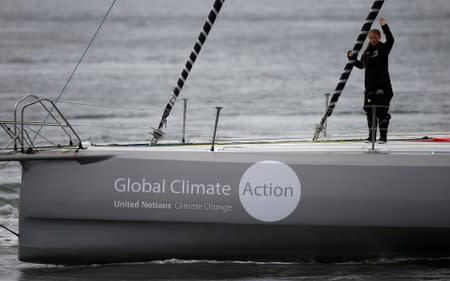 Swedish teenage climate activist Greta Thunberg waves from a yacht as she starts her trans-Atlantic boat trip to New York, in Plymouth