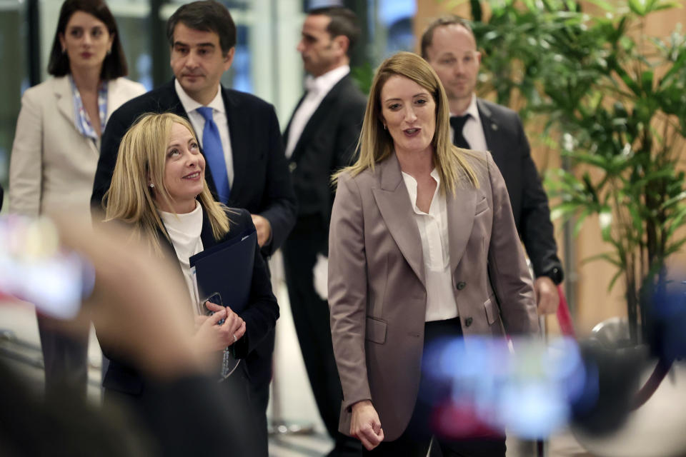 European Parliament President Roberta Metsola, right, walks with Italian Prime Minister Giorgia Meloni prior to a meeting at the European Parliament in Brussels, Thursday, Nov. 3, 2022. New Italian Prime Minister Giorgia Meloni visits EU officials on Thursday, and it is no ordinary visit of the leader of a European Union founding nation to renew unshakable bonds with the 27-nation bloc. (AP Photo/Olivier Matthys)