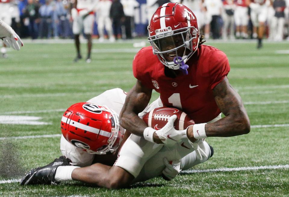 Alabama Crimson Tide wide receiver Jameson Williams (1) slides into the end zone for a touchdown against the George Bulldogs during the SEC championship game at Mercedes-Benz Stadium. Alabama won 41-24.