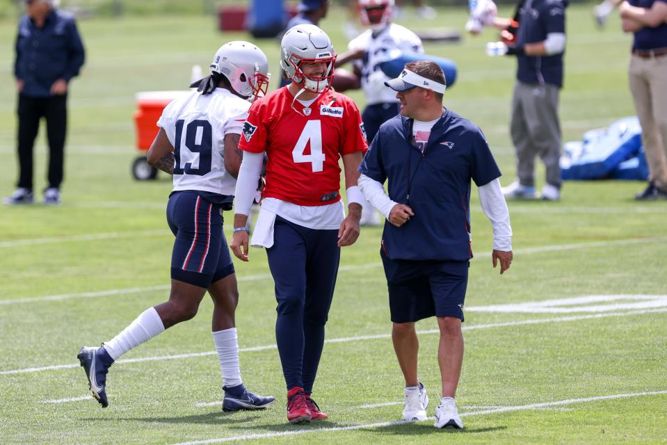 New England Patriots quarterback Jarrett Stidham (4) talks to offensive coordinator Josh McDaniels during OTAs at the New England Patriots practice complex on June 10, 2021.