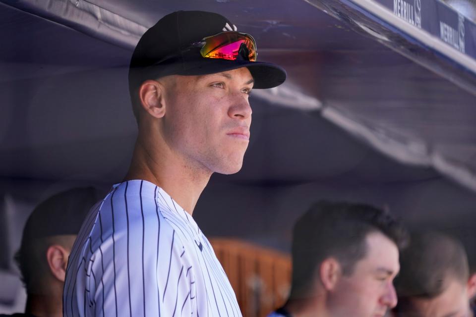 Aaron Judge watches from the dugout in the seventh inning of a game.