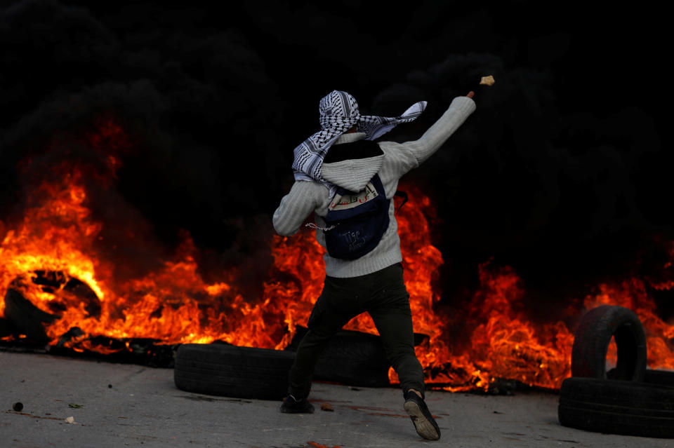 A Palestinian protester hurls stones towards Israeli troops during clashes near the Jewish settlement of Beit El, near the West Bank city of Ramallah December 7, 2017.&nbsp;