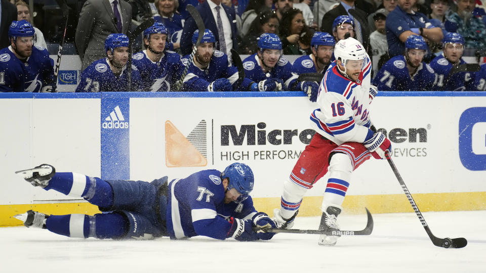 Tampa Bay Lightning defenseman Victor Hedman (77) falls down as New York Rangers center Vincent Trocheck (16) moves the puck during the first period of an NHL hockey game Saturday, Dec. 30, 2023, in Tampa, Fla. (AP Photo/Chris O'Meara)