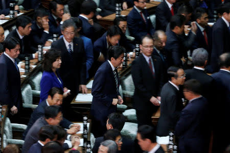 Japan's Prime Minister Shinzo Abe (C) walks to cast a ballot at the Lower House of the Parliament in Tokyo, Japan, November 1, 2017. REUTERS/Toru Hanai