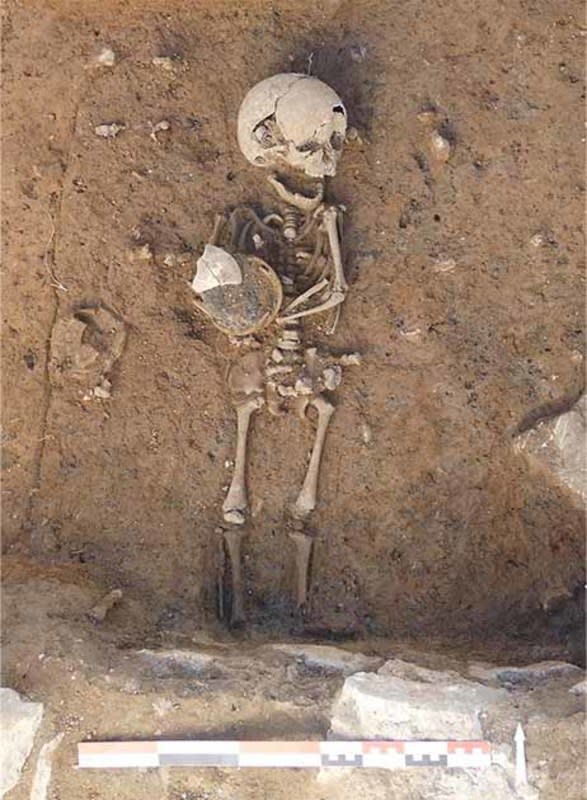Archaeologists found the skeletal remains of a small child clutching a ceramic vase.<p>Archaeology News / J Grimaud / INRAP</p>
