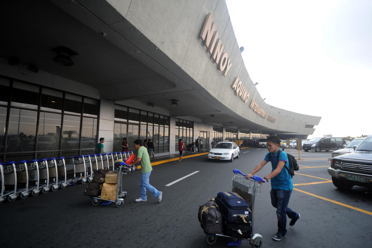 FILE PHOTO: Passengers arrive at the Ninoy Aquino International Airport (NAIA) Terminal 1 in Pasay City, Metro Manila, the Philippines. (Photo: NOEL CELIS/AFP via Getty Images)