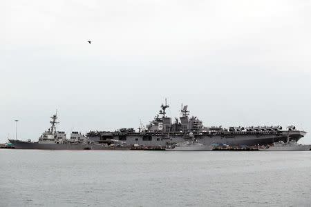 The damaged USS John McCain (L) and the USS America are docked at Changi Naval Base in Singapore August 22, 2017. REUTERS/Calvin Wong NO RESALES. NO ARCHIVES