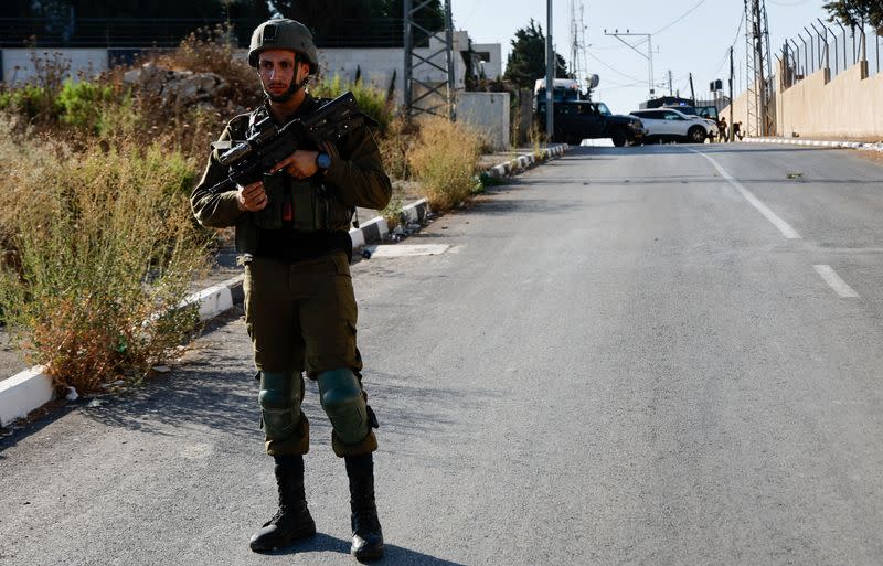 Israeli troops stand guard at the scene where three Palestinians who fired at Israeli forces were allegedly killed by Israeli troops, in Nablus