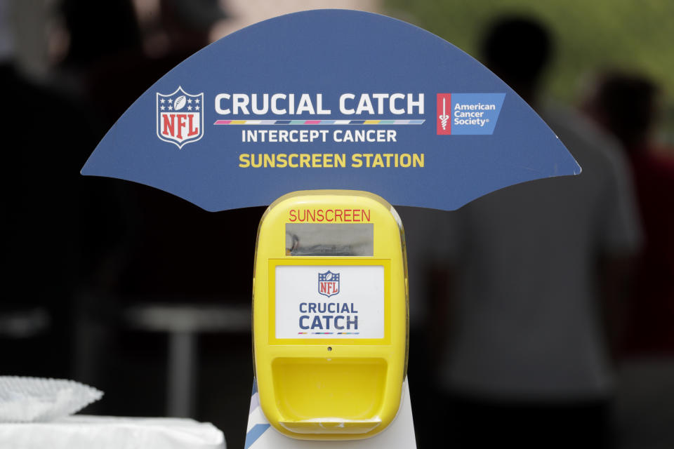 A sunscreen dispenser is seen in the fan section at the New York Giants NFL football training camp, Thursday, Aug. 2, 2018, in East Rutherford, N.J. The NFL and American Cancer Society teamed up this summer to launch an initiative as part of its "Crucial Catch" campaign in which free sunscreen is being provided to players, coaches, fans, team employees and media at camps across the country. (AP Photo/Julio Cortez)