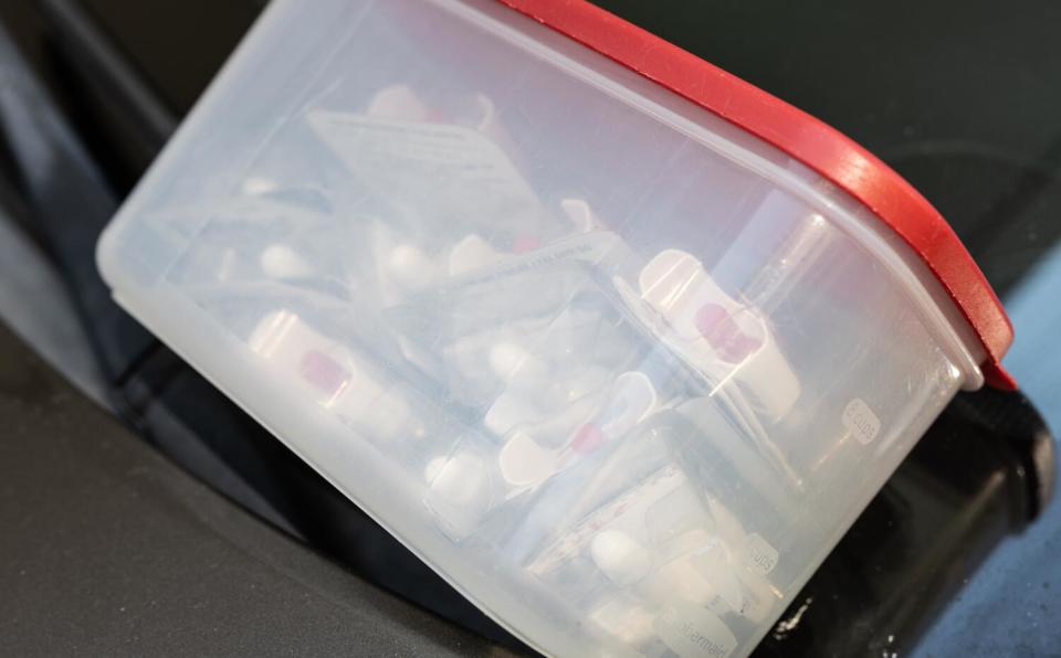 A container of Narcan sits on a windshield of a car at an illegal injection pop-up site in San Francisco.