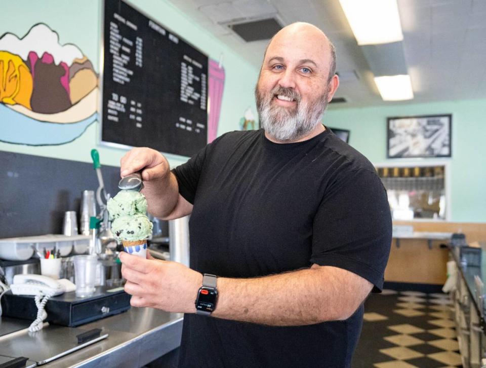 General Manager David Gilson puts two scoops of Mint Chip ice cream on a cone at Vic’s Ice Cream earlier this month.