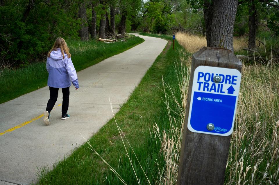 A woman walks along the Poudre Trail in Fort Collins on May 24. Larimer County and the town of Timnath received a grant from Colorado Parks and Wildlife to construct the remaining 1-mile segment of the Poudre Trail between Timnath and Windsor.