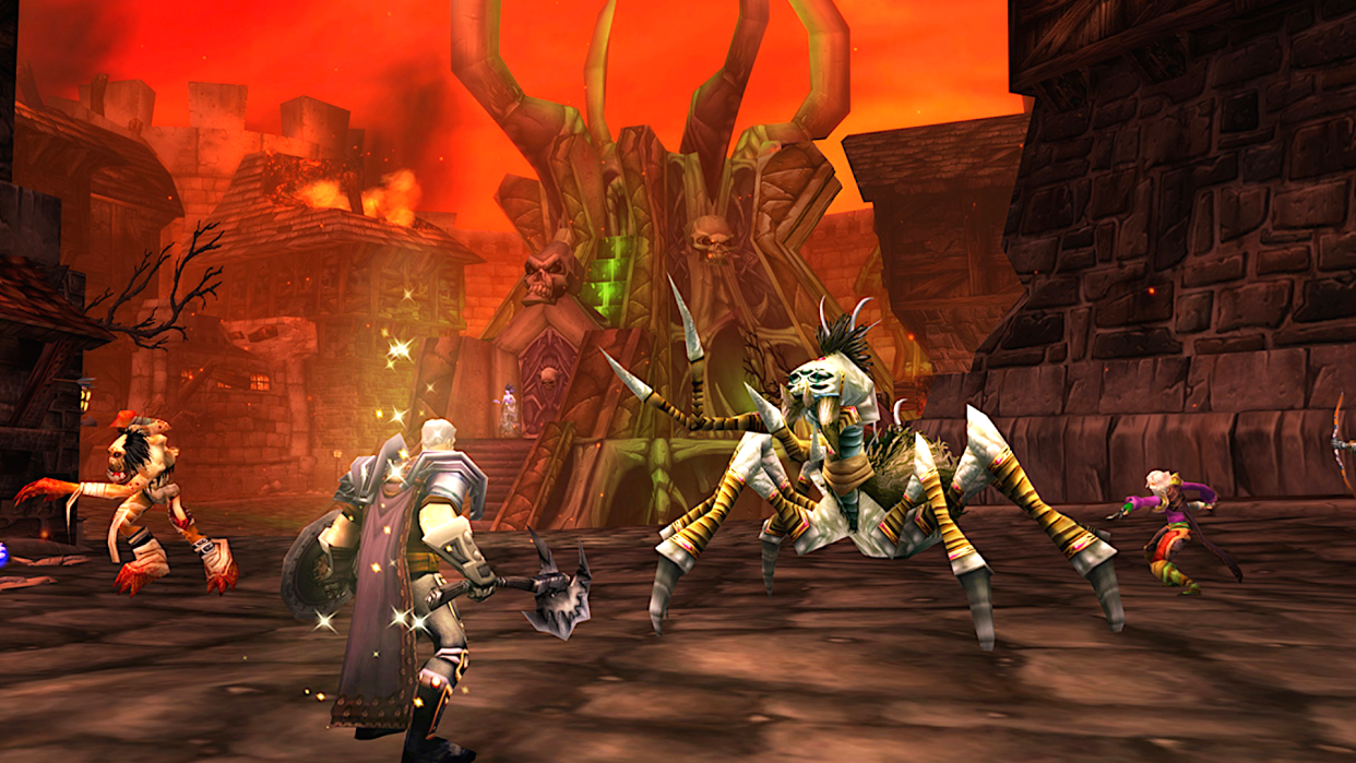  Several adventurers do battle in Stratholme in World of Warcraft: Classic, a firey undead necropolis filled with monsters. 