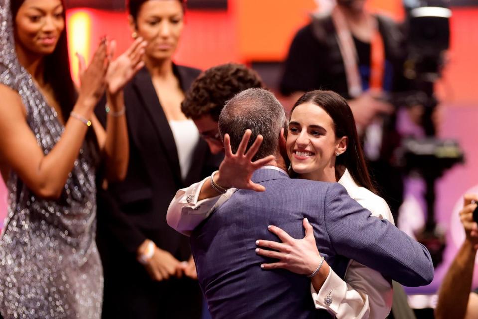 PHOTO: Iowa's Caitlin Clark, right, hugs her father Brent Clark after being selected first overall by the Indiana Fever during the first round of the WNBA basketball draft, April 15, 2024, in New York. (Adam Hunger/AP)