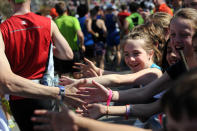 HOPKINTON, MA - APRIL 16: Children slap high fives with passing runners at the start of the 116th running of the Boston Marathon April 16, 2012 in Hopkinton, Massachusetts. (Photo by Darren McCollester/Getty Images)