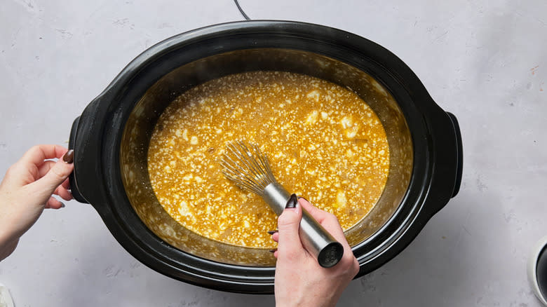 stirring cheese into slow cooker