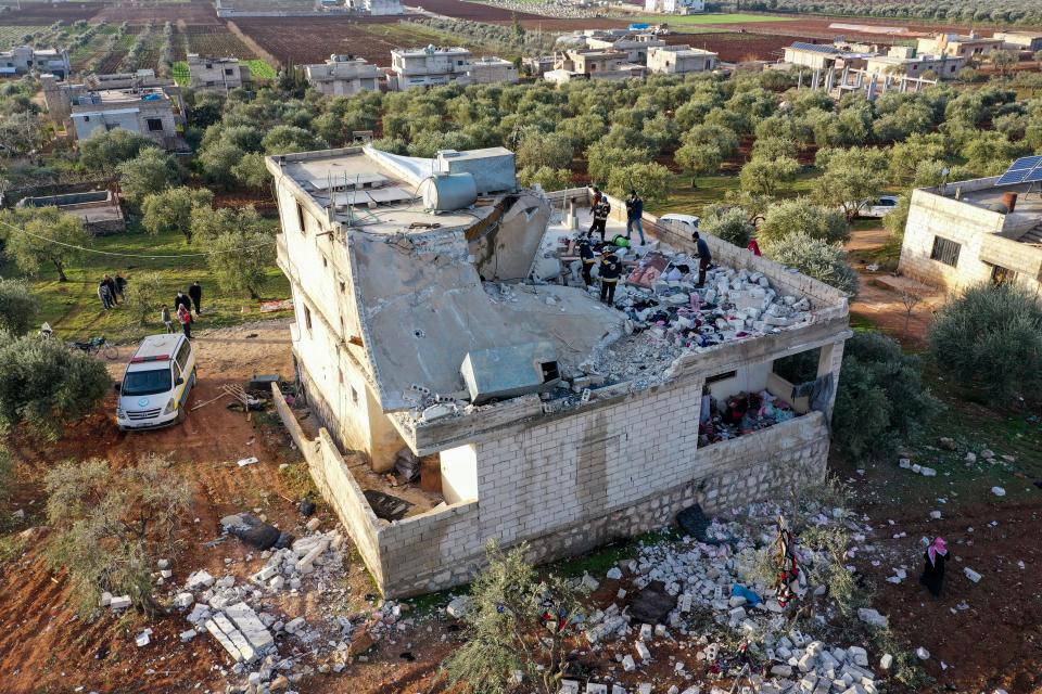 People inspect a destroyed house following an operation by the U.S. military in the Syrian village of Atmeh, in Idlib province, Syria, Thursday, Feb. 3, 2022 (AP)