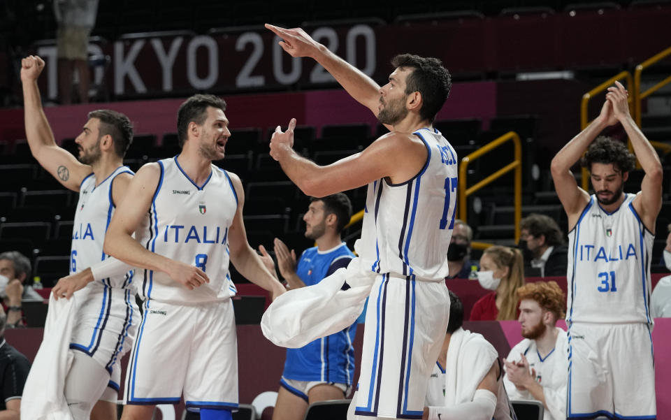 Italy players celebrate scoring by a teammate during men's basketball preliminary round game against Nigeria at the 2020 Summer Olympics, Saturday, July 31, 2021, in Saitama, Japan. (AP Photo/Eric Gay)