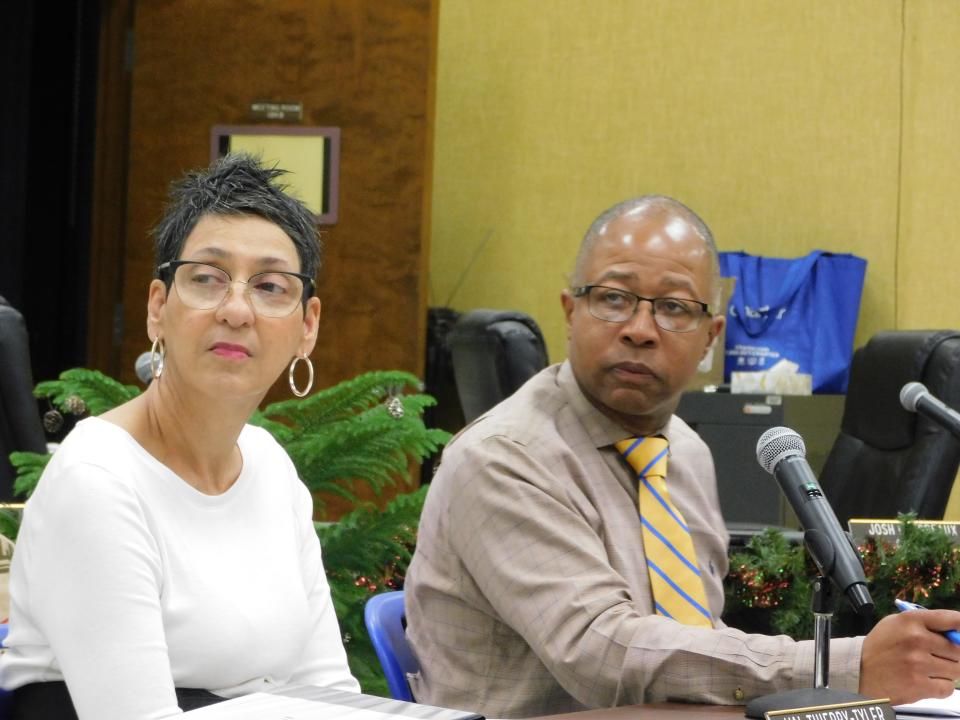 St. Landry Parish School Superintendent Patrick Jenkins and central office secretary Val Tyler view a presentation Monday night at a committee meeting.