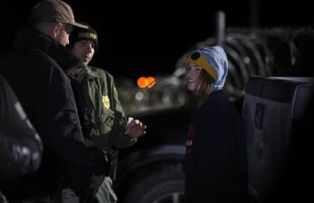 A woman is detained by law enforcement after crossing into Area 51 as an influx of tourists responding to a call to 'storm' Area 51 is expected in Rachel