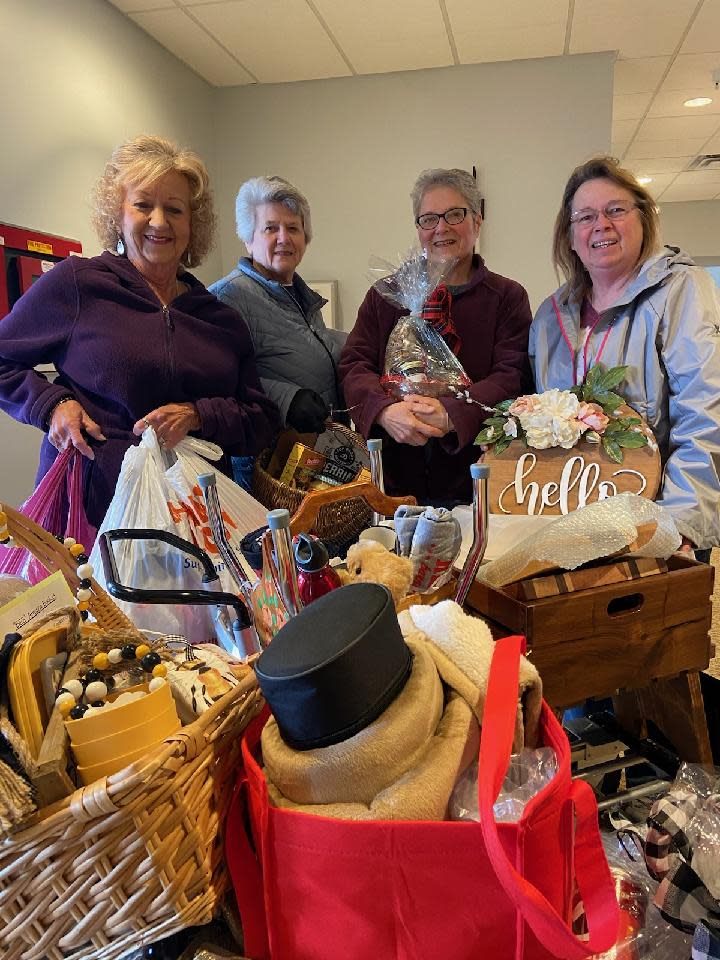 Marylyn Strang, left, Virginia Hammontree, Kathy Wells and Linda Cooperider unload donations for the Rotary Auctionfest in 2022. This year's event is April 13 at the Wynford Community Center. (FILE PHOTO PROVIDED BY MARY LEE MINOR)