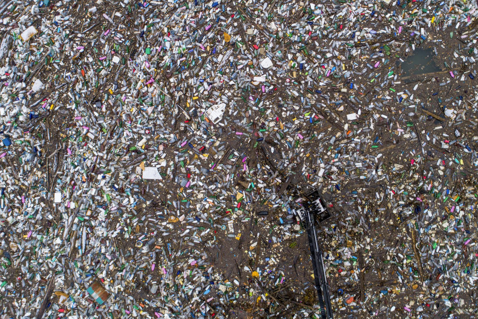 Aerial view of waste floating in the Drina river near Visegrad, Bosnia, Wednesday, Jan. 10, 2024. Tons of waste dumped in poorly regulated riverside landfills or directly into the rivers across three Western Balkan countries end up accumulating during high water season in winter and spring, behind a trash barrier in the Drina River in eastern Bosnia. (AP Photo/Armin Durgut)